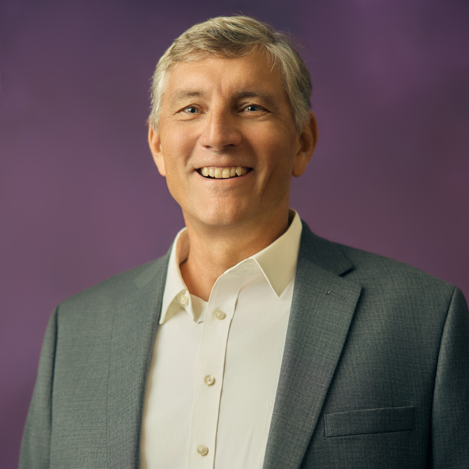 Meet The Team A smiling man with gray hair wearing a gray suit jacket and white shirt in Williamson County, Tennessee.