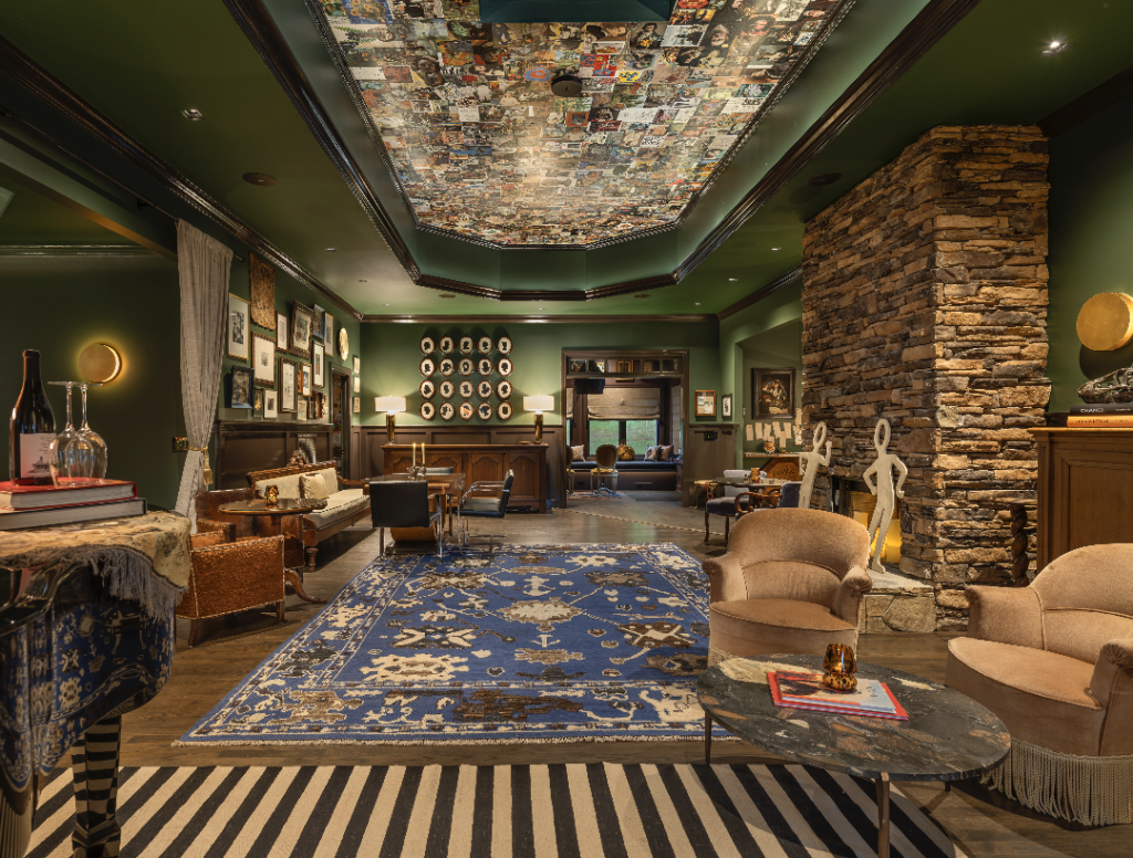 A luxurious living room with a stone fireplace, plush seating, and a unique ceiling mosaic in Williamson County, Tennessee.