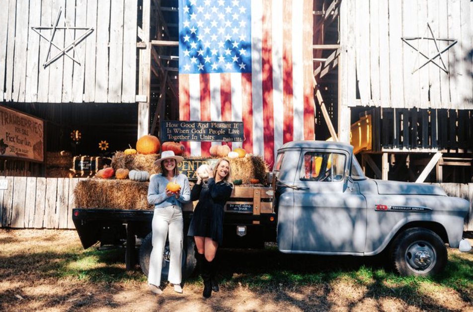 Perfect Pairings for Making the Most of Fall in Franklin Two women stand beside a vintage pickup truck filled with pumpkins and hay bales in front of a barn in Williamson County, Tennessee.