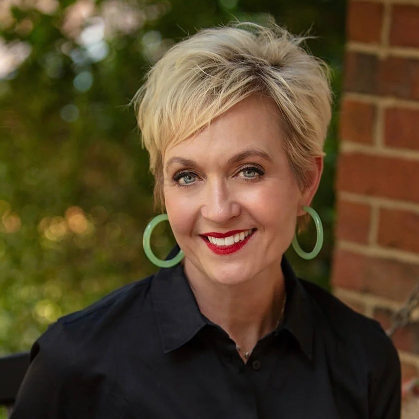 Sherri Hughes-Gragg | Book Signing A woman with short blonde hair and red lipstick smiles at the camera in Williamson County, Tennessee.