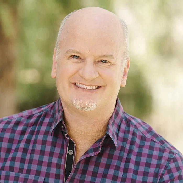 Allen Wolf | Book Signing A smiling bald man with a goatee wearing a purple and blue checkered shirt in Williamson County, Tennessee.