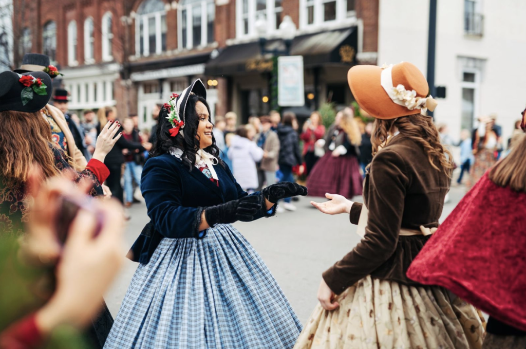 Celebrating Christmas in Franklin, Tennessee: A Guide to Local Holiday Traditions Women in historical costumes dance in a festive parade on a city street in Williamson County, Tennessee.