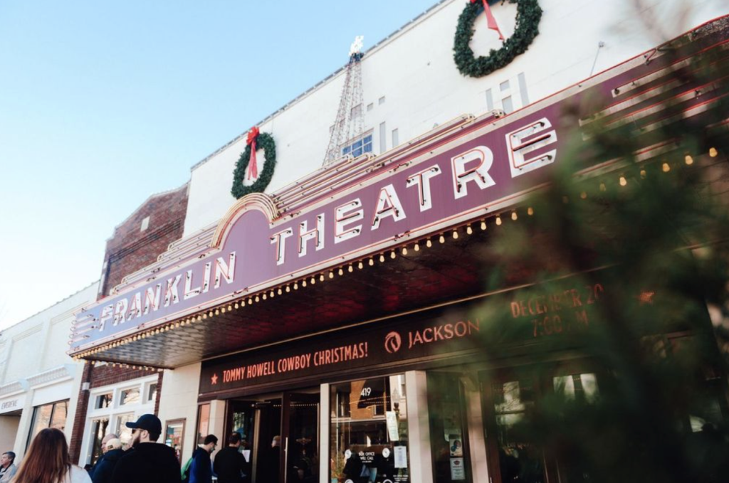 A festive theater marquee adorned with wreaths and lights advertises a Christmas show in Williamson County, Tennessee.