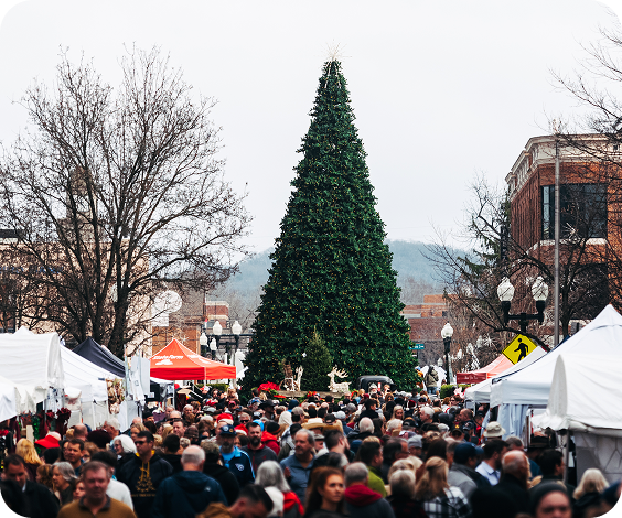 A bustling outdoor market with a large Christmas tree as the centerpiece in Williamson County, Tennessee.