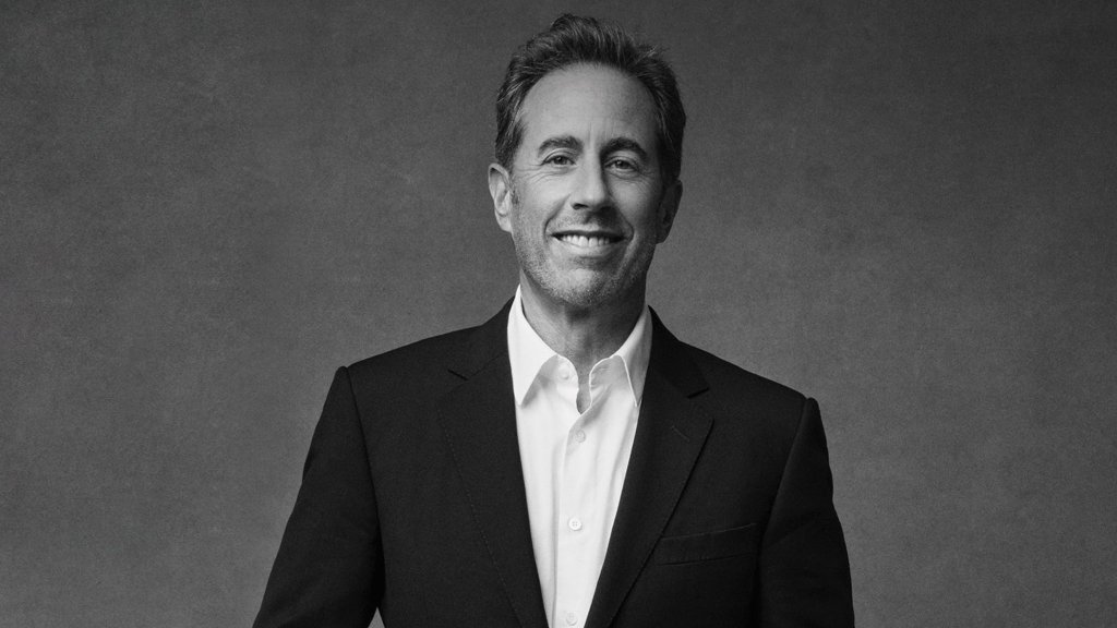 A man in a black suit and white shirt smiles warmly at the camera against a plain background in Williamson County, Tennessee.
