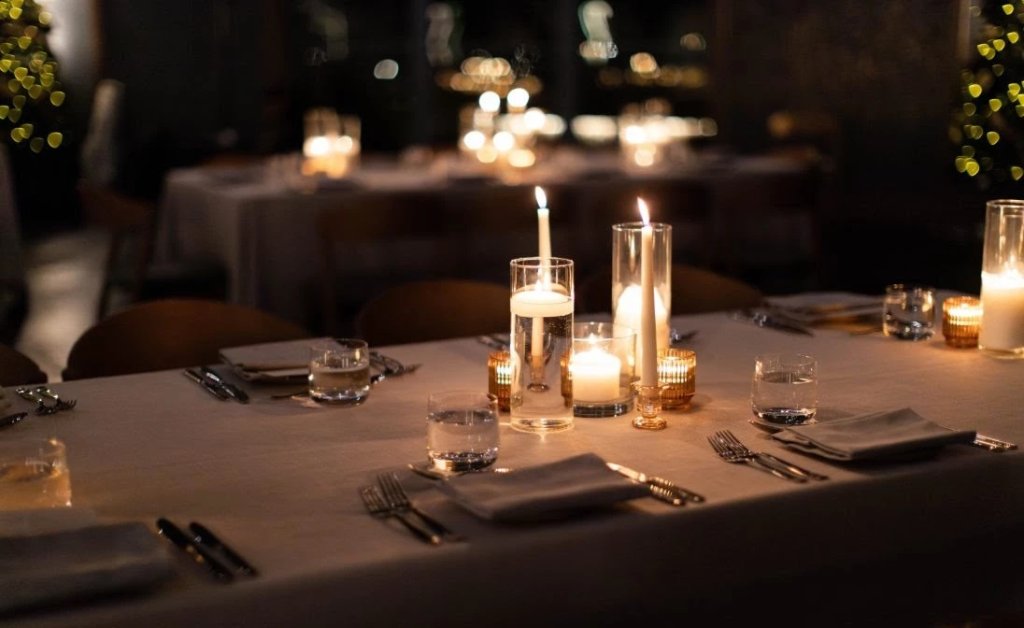 Elegantly set dining table with flickering candles and fine china, creating a warm and inviting atmosphere in Williamson County, Tennessee.