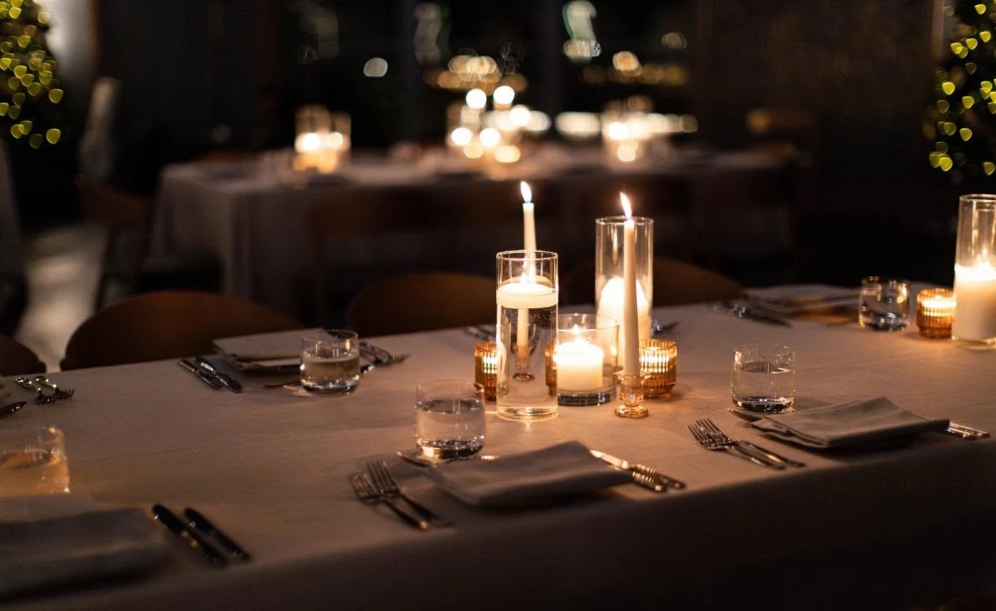 Elegantly set dining table with flickering candles and fine china, creating a warm and inviting atmosphere in Williamson County, Tennessee.