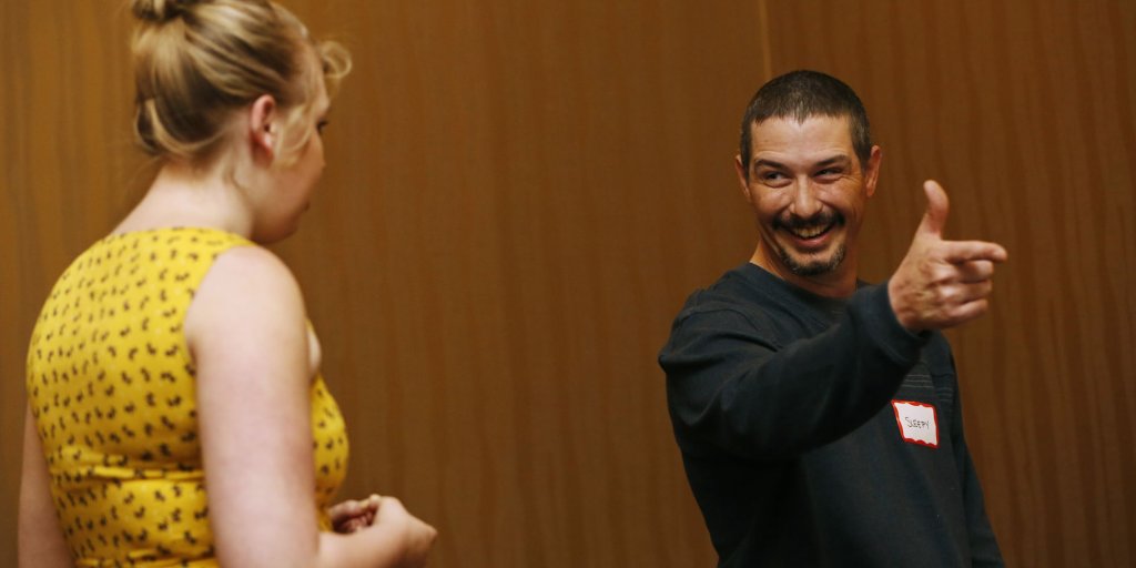 A man and a woman are engaged in a lively conversation, with the man pointing and smiling broadly in Williamson County, Tennessee.