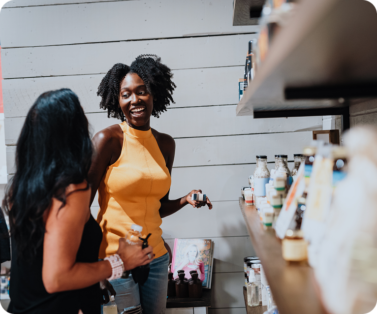 Two women are browsing and discussing products on a store shelf in Williamson County, Tennessee.