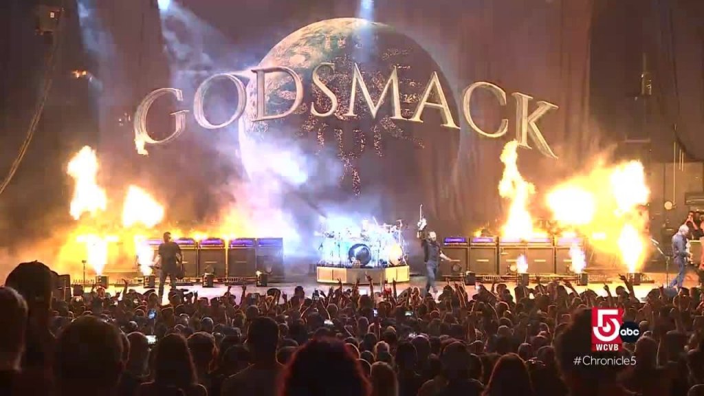 Godsmack performs on stage with a massive globe backdrop and fiery explosions in Williamson County, Tennessee.