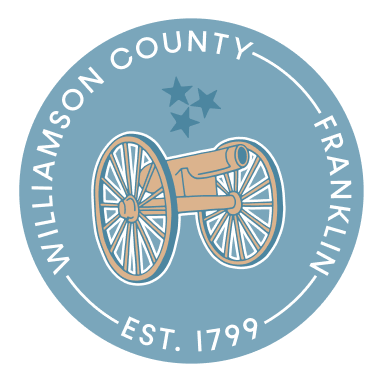 A circular emblem featuring a cannon on wheels with stars above, representing Williamson County, Franklin, established in 1799 in Williamson County, Tennessee.