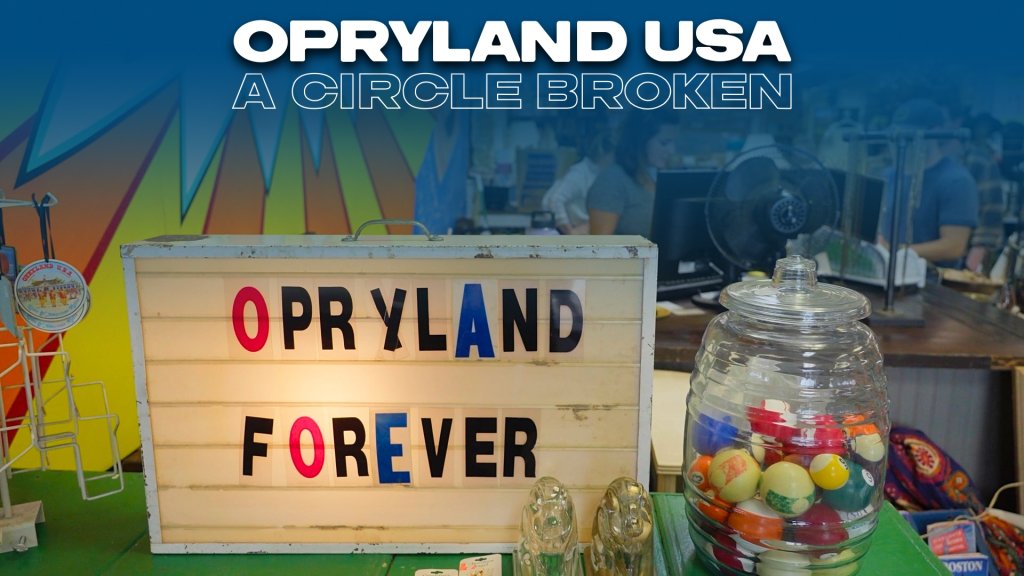 A vintage-style sign reading 'OPRYLAND USA A CIRCLE BROKEN' with colorful letters, accompanied by a jar of colorful balls and other items on a table in Williamson County, Tennessee.