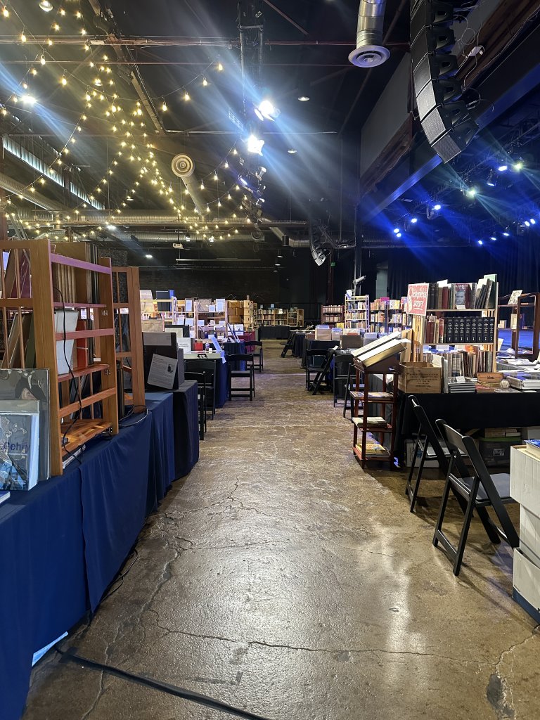 A spacious indoor venue with high ceilings, filled with tables and chairs, and adorned with string lights, creating a warm and inviting atmosphere in Williamson County, Tennessee.