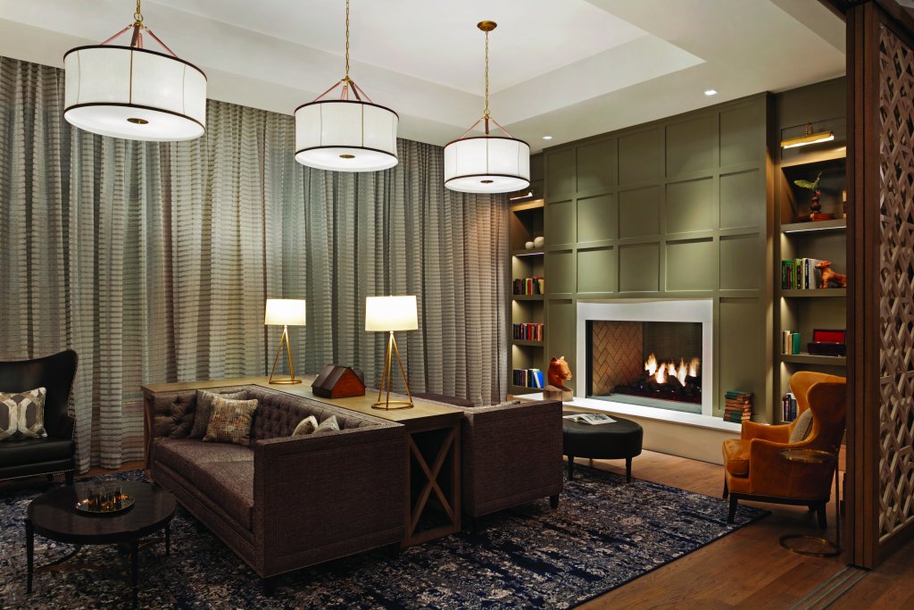 Plan the Perfect Reading Retreat in Franklin, TN with These Cozy Bookstores & Scenic Nooks A cozy living room with a fireplace, plush sofas, and elegant lighting fixtures in Williamson County, Tennessee.