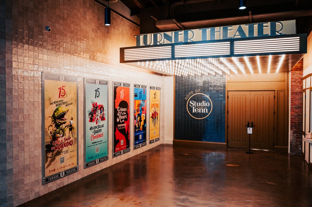 A vintage-style movie theater lobby with posters for upcoming films and a marquee sign reading 'Turner Theater' in Williamson County, Tennessee.