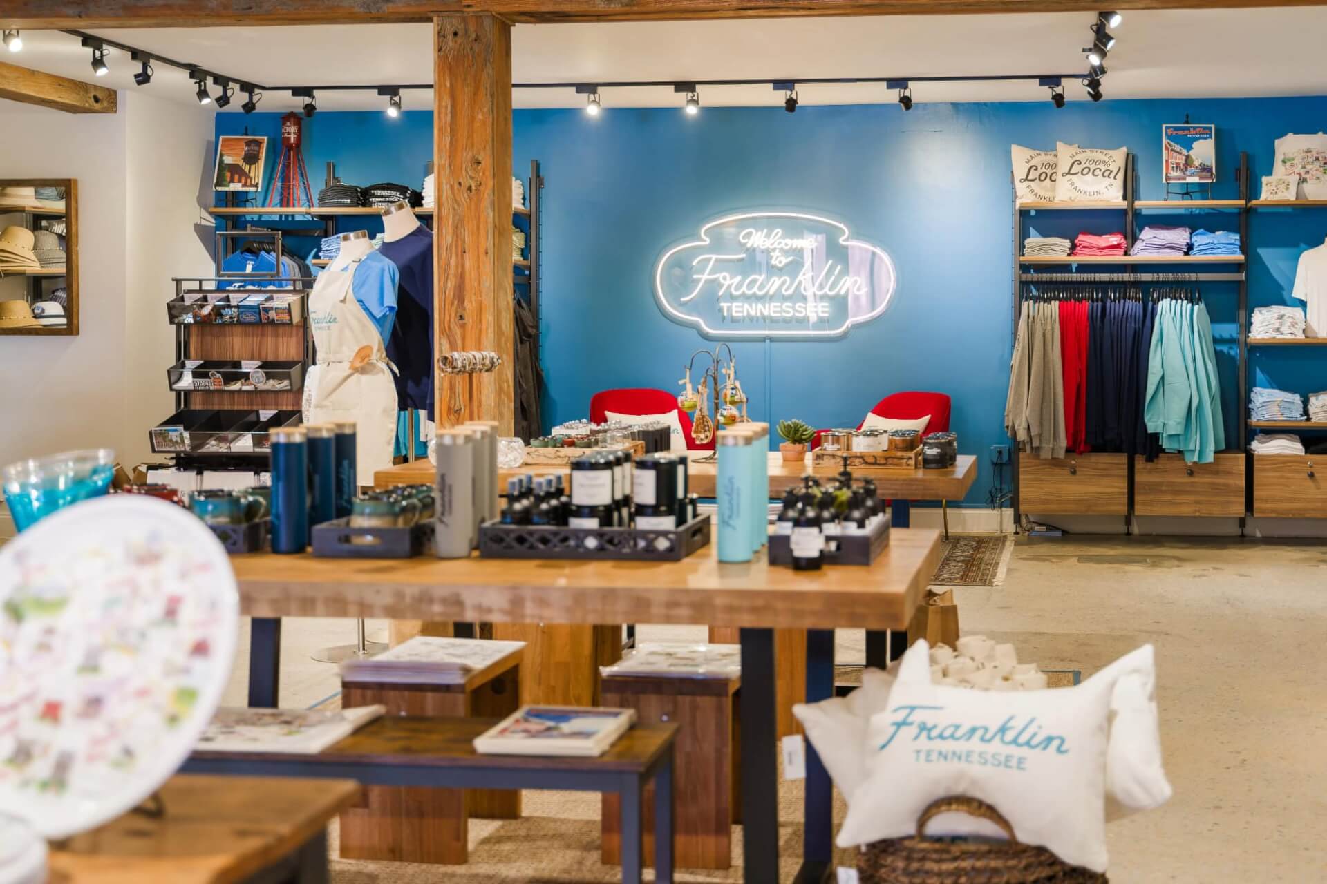 A cozy boutique in Franklin, Tennessee, with a welcoming neon sign and shelves filled with local goods and clothing in Williamson County, Tennessee.