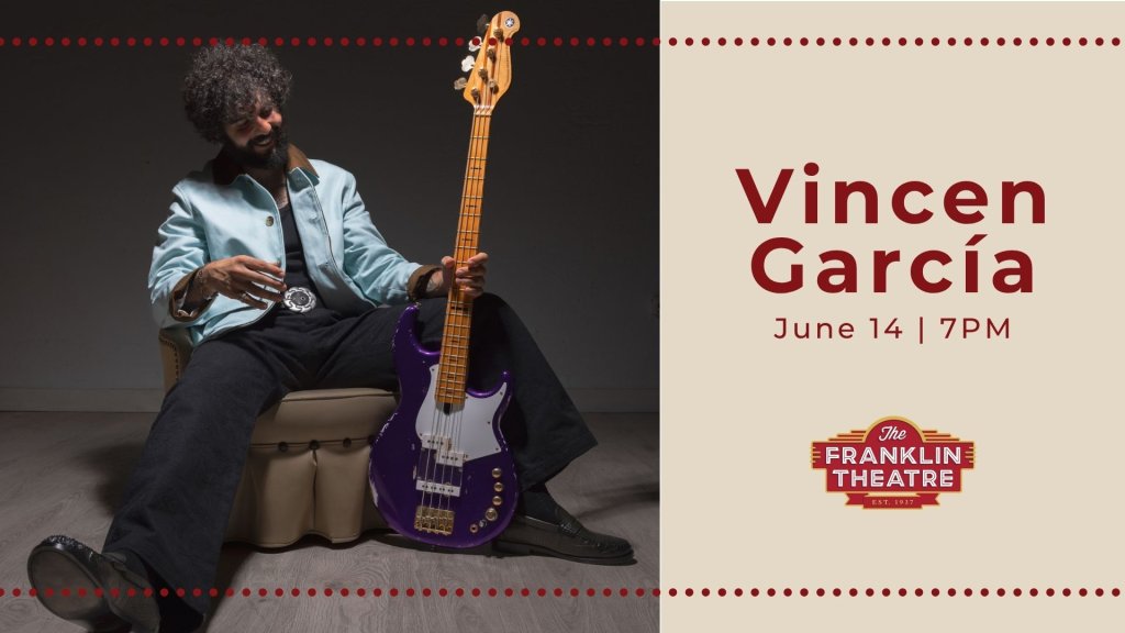 Events A musician with an afro playing a purple electric bass guitar while seated on a stool in Williamson County, Tennessee.