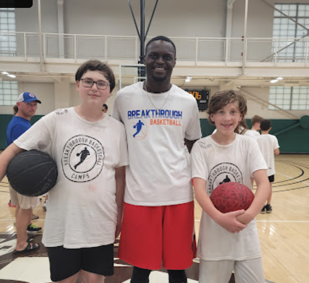 Three young boys proudly pose with basketballs, wearing matching 'Breakthrough Basketball' shirts in Williamson County, Tennessee.