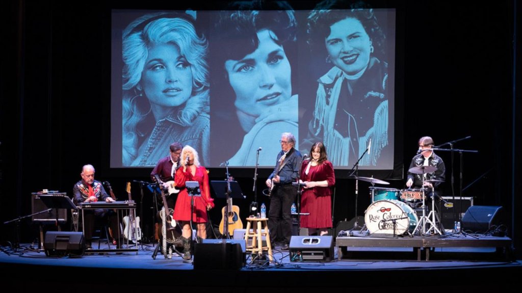 Events A band performs on stage with a backdrop of iconic female country music stars projected on a large screen in Williamson County, Tennessee.