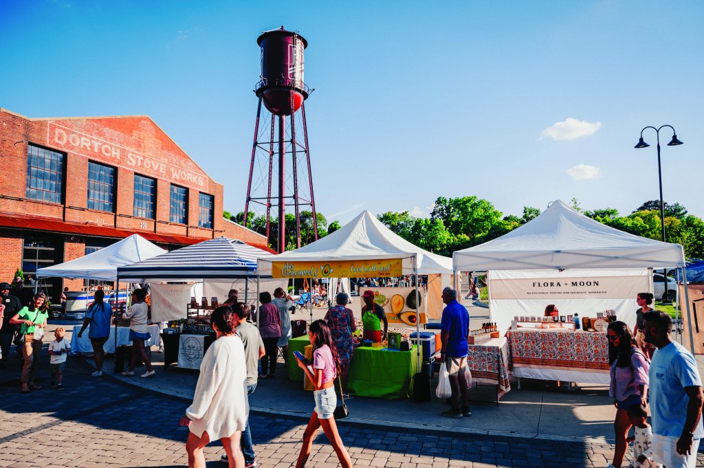 Your Best Summer Break Ever: Top Kid-Friendly Activities in Franklin, Tennessee A bustling outdoor market with colorful tents, a historic water tower, and a lively crowd shopping and socializing in Williamson County, Tennessee.