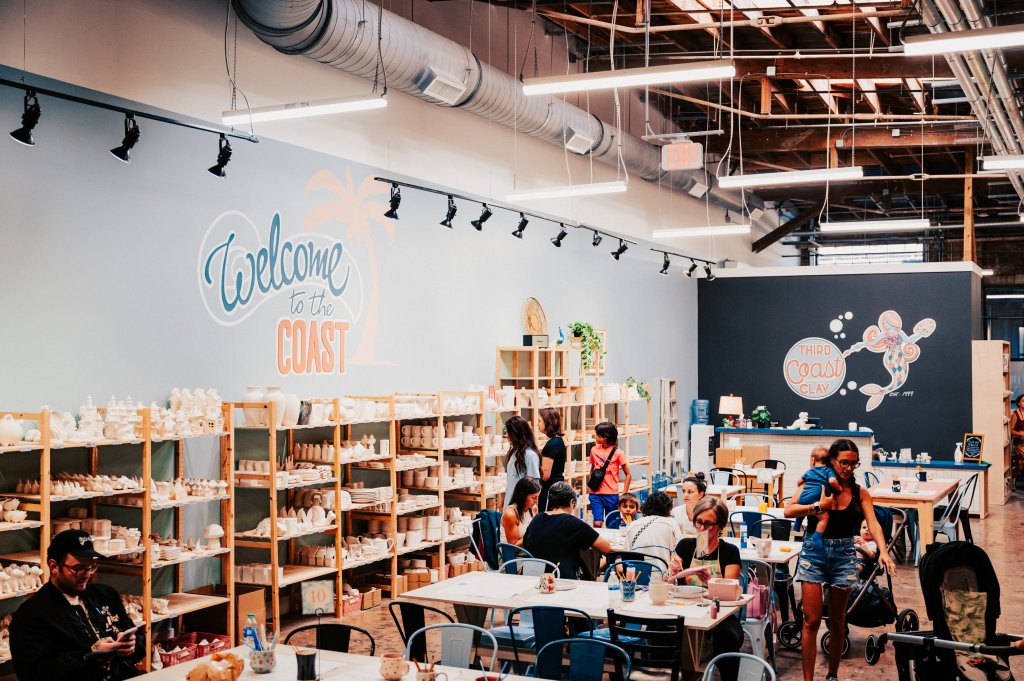 Your Best Summer Break Ever: Top Kid-Friendly Activities in Franklin, Tennessee A bustling ceramic studio with people painting pottery and enjoying refreshments at tables in Williamson County, Tennessee.