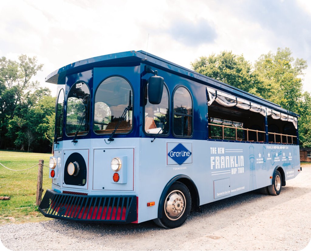 Top 10 Things to Do in Franklin A blue and light blue Gray Line tour trolley parked on a gravel lot in Williamson County, Tennessee.
