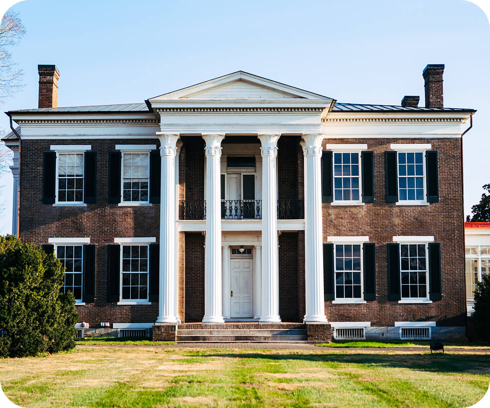 Top 10 Things to Do in Franklin A grand brick mansion with white columns and black shutters under a clear sky in Williamson County, Tennessee.