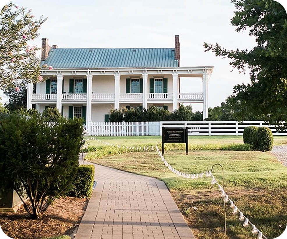 Top 10 Things to Do in Franklin A historic white two-story house with a porch and green shutters behind a fence in Williamson County, Tennessee.