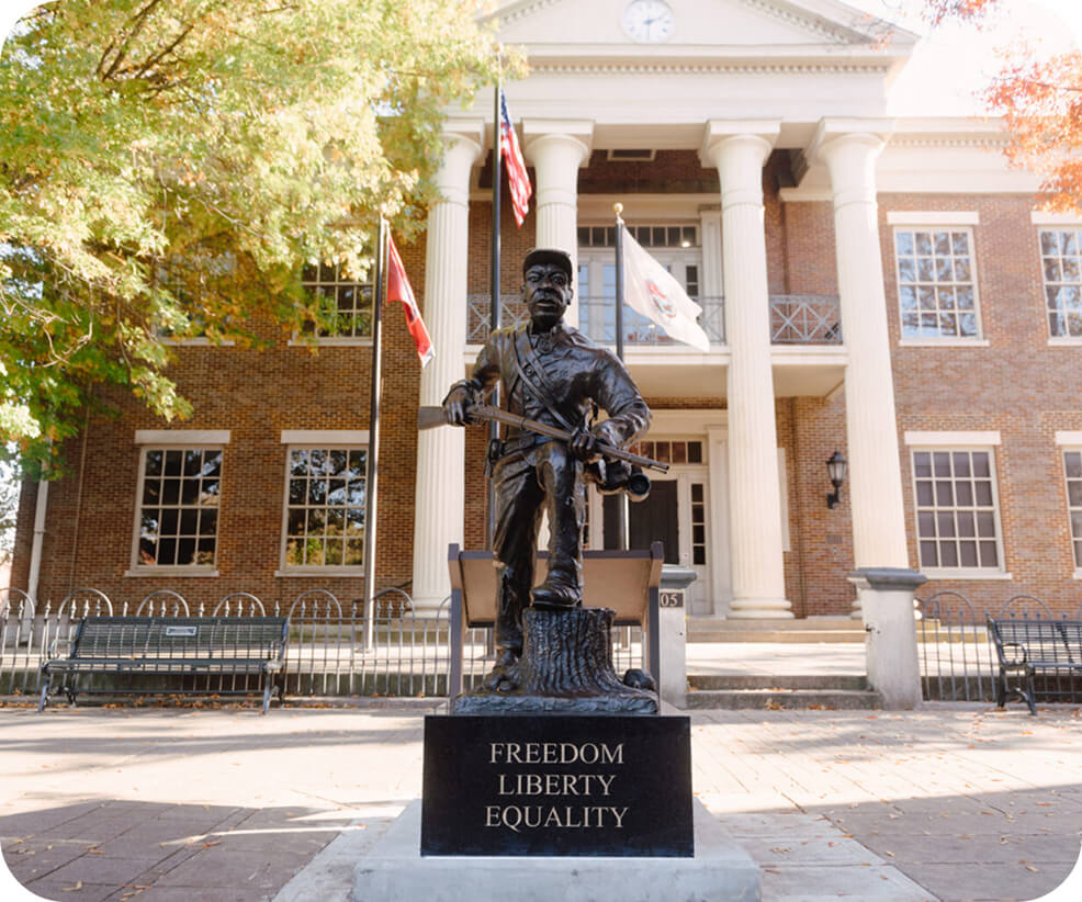 Top 10 Things to Do in Franklin A bronze statue of a soldier standing before a historic brick building in Williamson County, Tennessee.