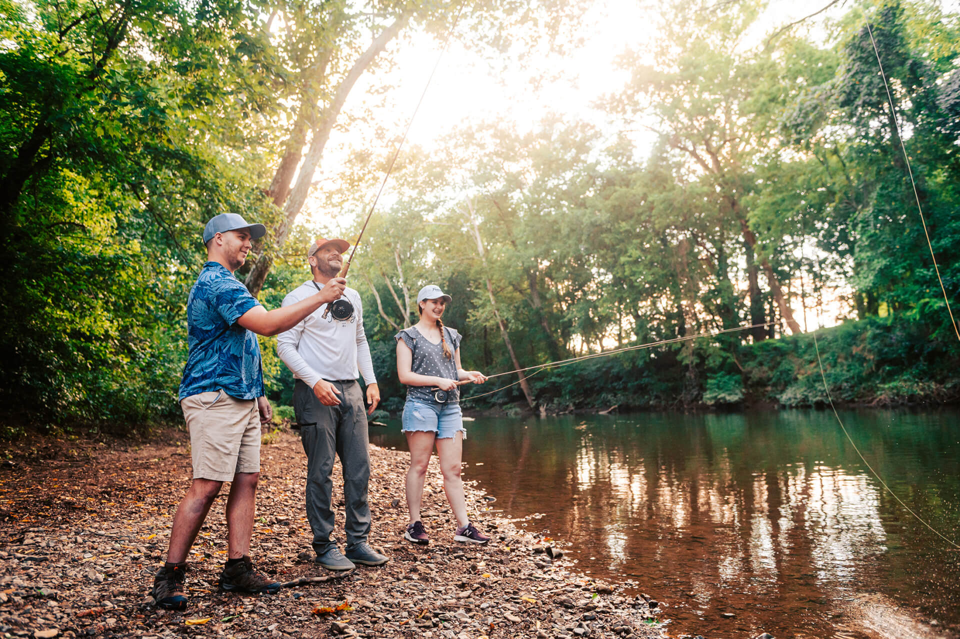 Top 10 Things to Do in Franklin Three people fly fishing together on a sunny riverbank in Williamson County, Tennessee.