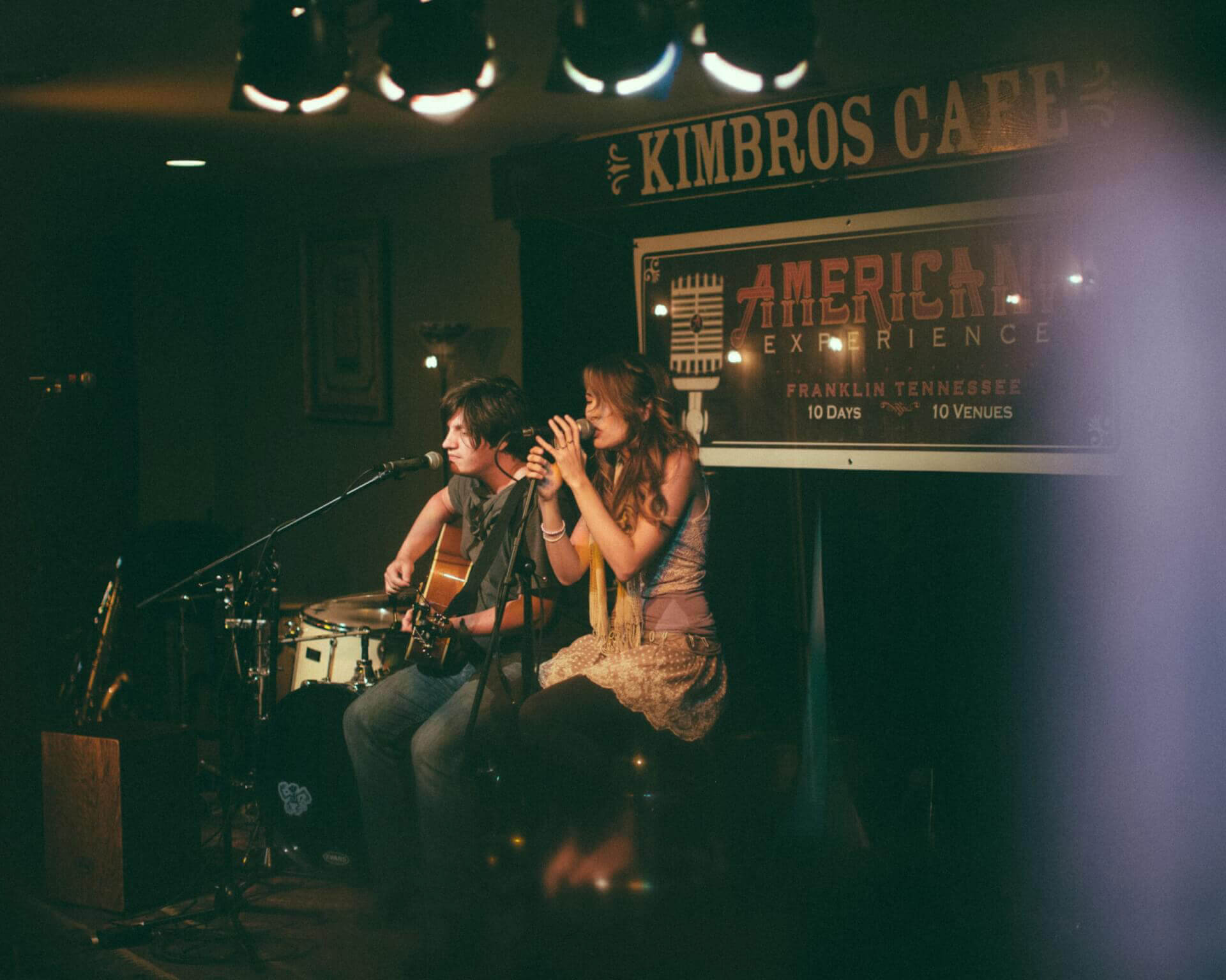 Top 10 Things to Do in Franklin A man playing guitar and a woman singing on stage at a cafe in Williamson County, Tennessee.