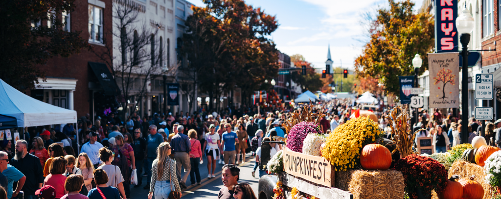 PumpkinFest A crowded street festival with autumn decorations, pumpkins, and fall foliage in Williamson County, Tennessee.