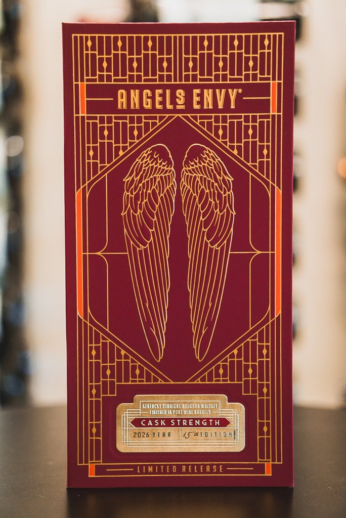 A maroon box for Angel's Envy Cask Strength bourbon with gold art deco wing designs in Williamson County, Tennessee.
