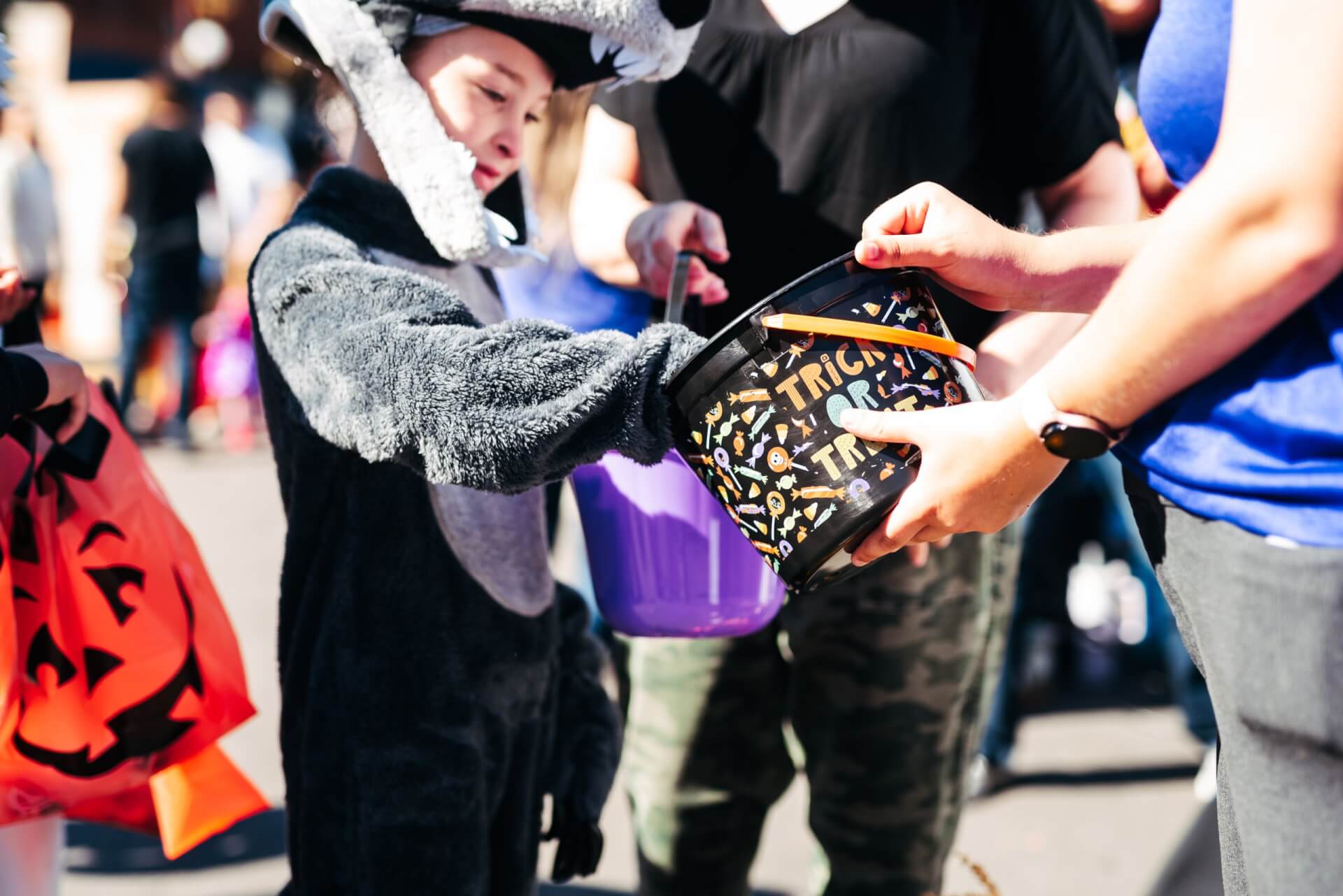PumpkinFest A child in a wolf costume trick-or-treating with a candy bucket in Williamson County, Tennessee.