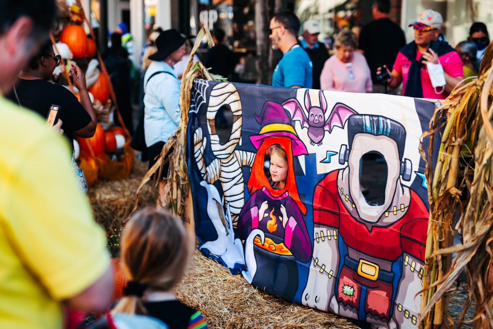 PumpkinFest A young girl poses behind a Halloween-themed photo cutout board at an outdoor event in Williamson County, Tennessee.