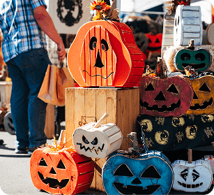 PumpkinFest A variety of colorful wooden jack-o'-lantern decorations displayed at an outdoor market in Williamson County, Tennessee.