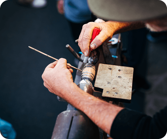 PumpkinFest A craftsman uses a tool to carve a small wooden barrel on a lathe in Williamson County, Tennessee.