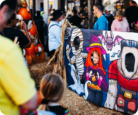 PumpkinFest A young girl poses for a photo behind a Halloween-themed cutout board in Williamson County, Tennessee.