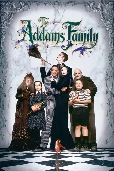 The Addams Family cast posing together for a movie poster on a checkered floor in Williamson County, Tennessee.