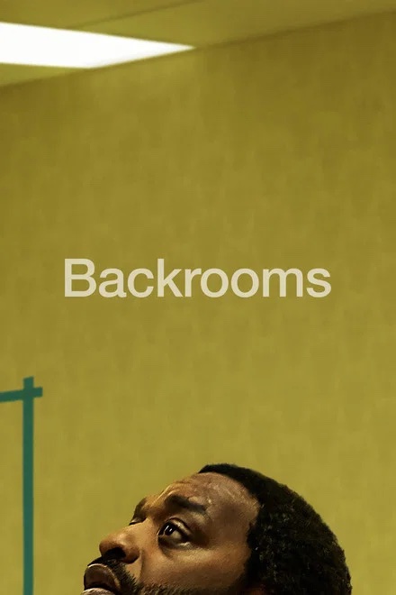 A man looks up at a yellow wall with the word Backrooms written on it in Williamson County, Tennessee.