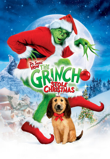The Grinch and his dog Max pose in front of a snowy Christmas village in Williamson County, Tennessee.
