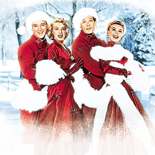 Two couples in matching red and white winter outfits pose in a snowy landscape in Williamson County, Tennessee.