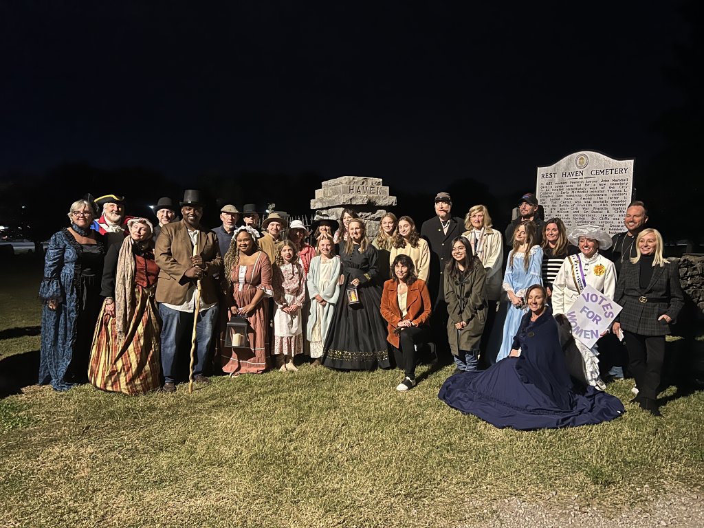 Events A group of people in historical costumes posing at Rest Haven Cemetery at night in Williamson County, Tennessee.