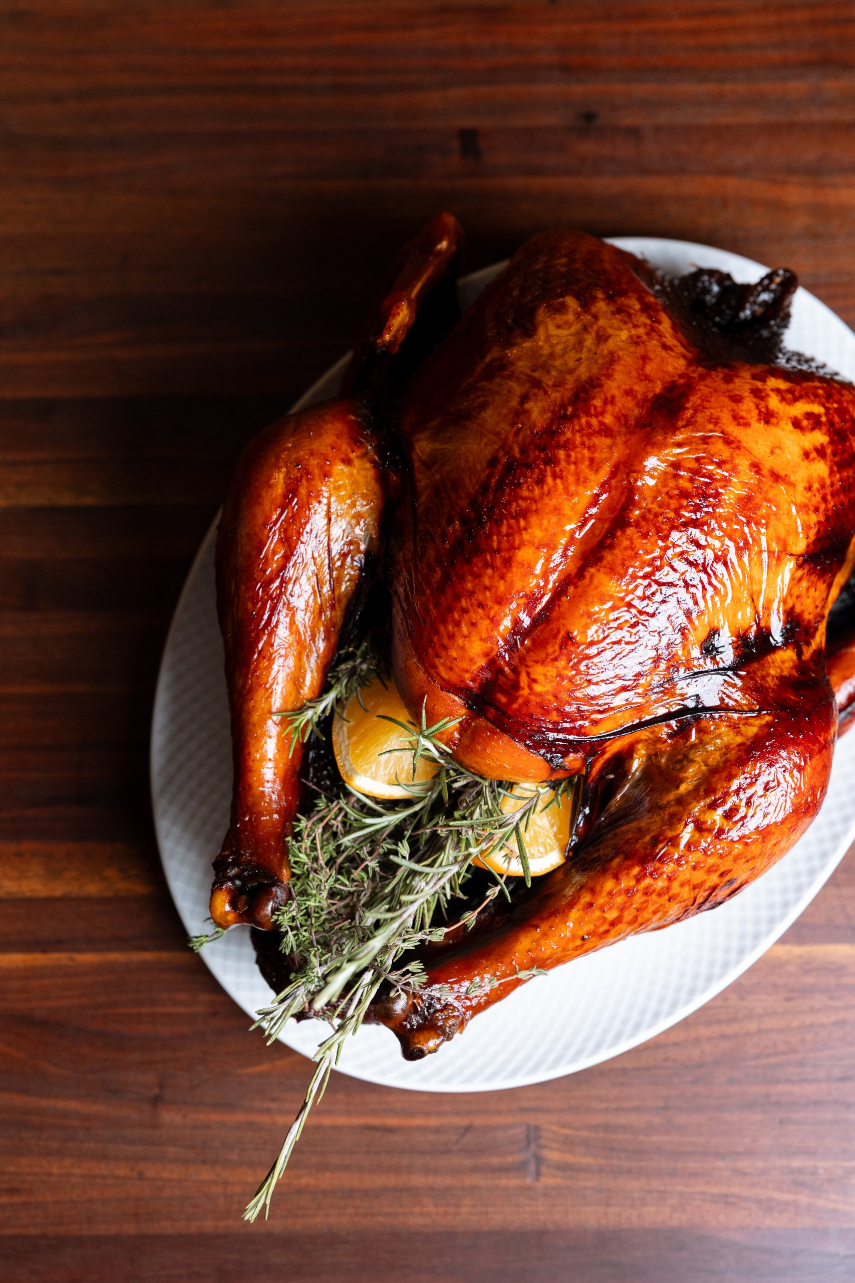 A roasted golden-brown turkey garnished with fresh rosemary and orange slices on a platter in Williamson County, Tennessee.