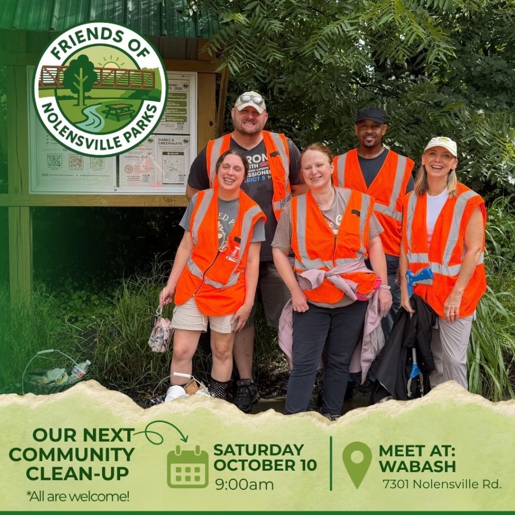 Events A group of volunteers in orange safety vests posing for a community cleanup event in Williamson County, Tennessee.