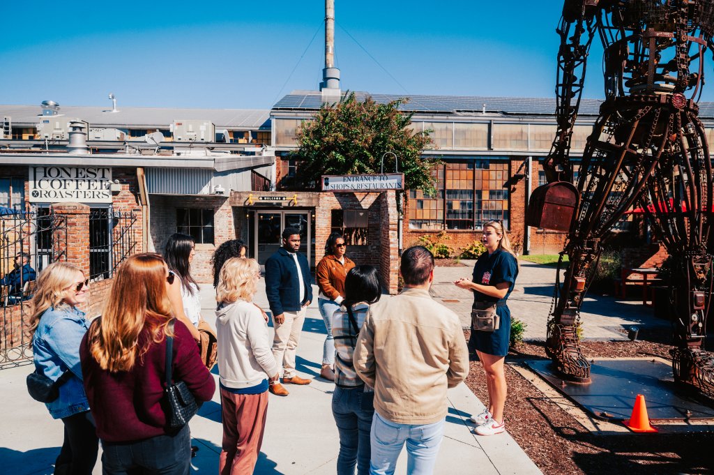 Discover the Surprisingly Unique Music History of Franklin, Tennessee A tour guide speaks to a group of people standing outside a brick building in Williamson County, Tennessee.