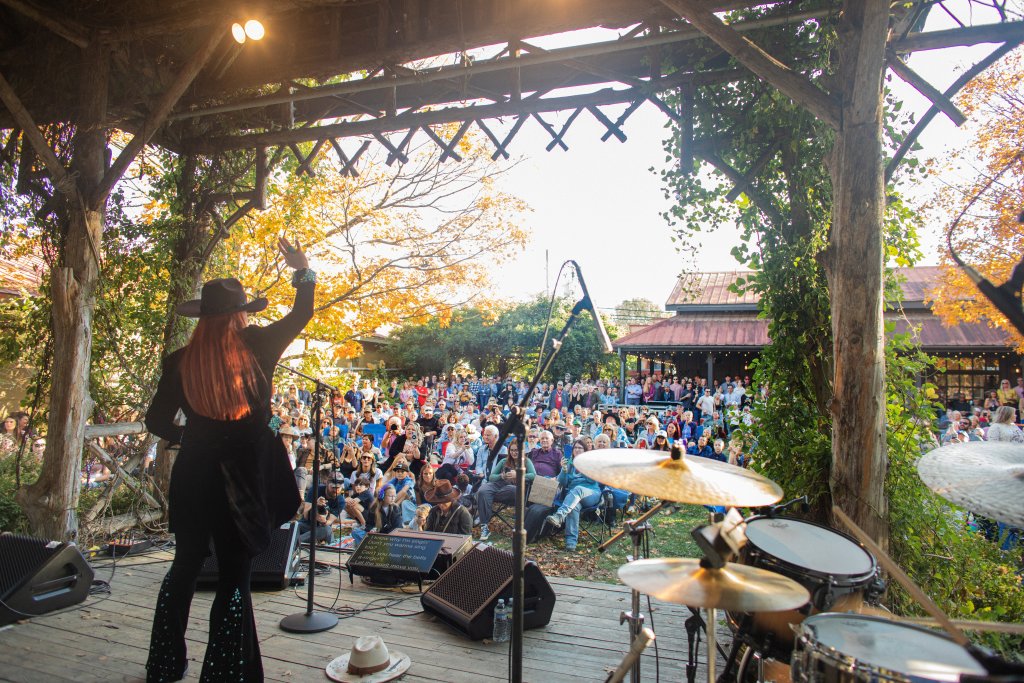 Discover the Surprisingly Unique Music History of Franklin, Tennessee A musician performs on an outdoor stage for a large seated audience in Williamson County, Tennessee.
