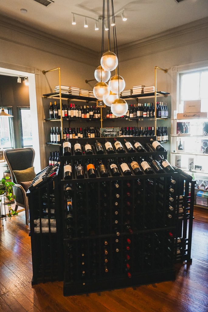 Autumn in Italy: A Red Wine Journey A well-stocked wine rack in a cozy, elegant shop with warm lighting in Williamson County, Tennessee.