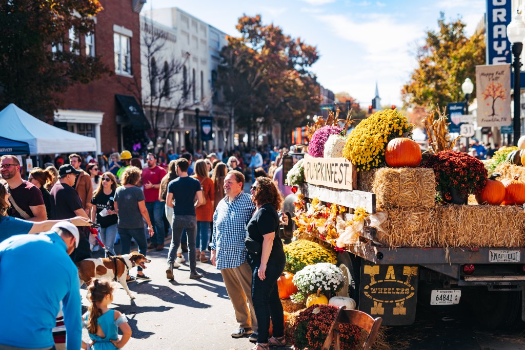 7 Delightfully Spooky Halloween Activities To Do This Season in Franklin, Tennessee A crowd gathers around a decorated truck at a sunny autumn street festival in Williamson County, Tennessee.