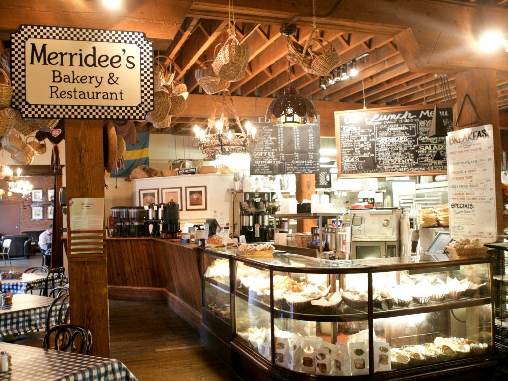 A Family Recipe, a Famous Bakery, and a Franklin Story: The Makings of Merridee's Breadbasket The interior of a rustic bakery and restaurant with a glass display case of pastries in Williamson County, Tennessee.